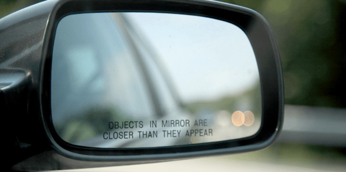 vehicles in a side view mirror of car are closer than they appear know why